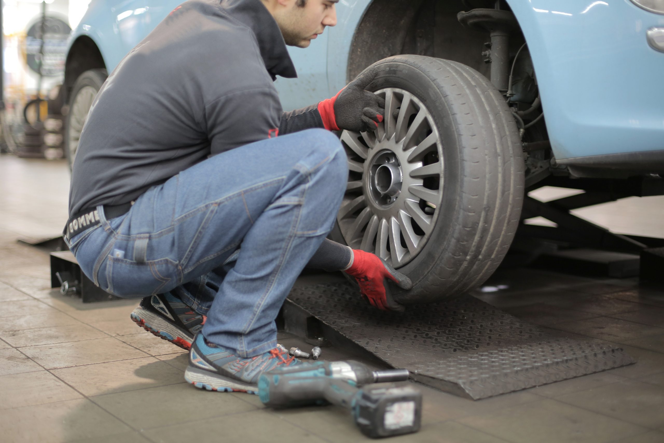 Man Changing a Car Tire Â· Free Stock Photo
