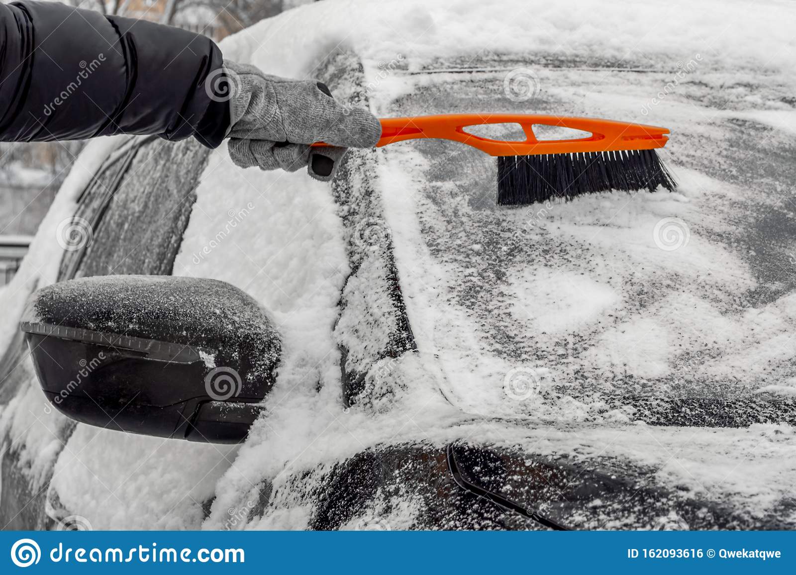 Man Using Brush To Remove Snow From The Car Stock Photo ...